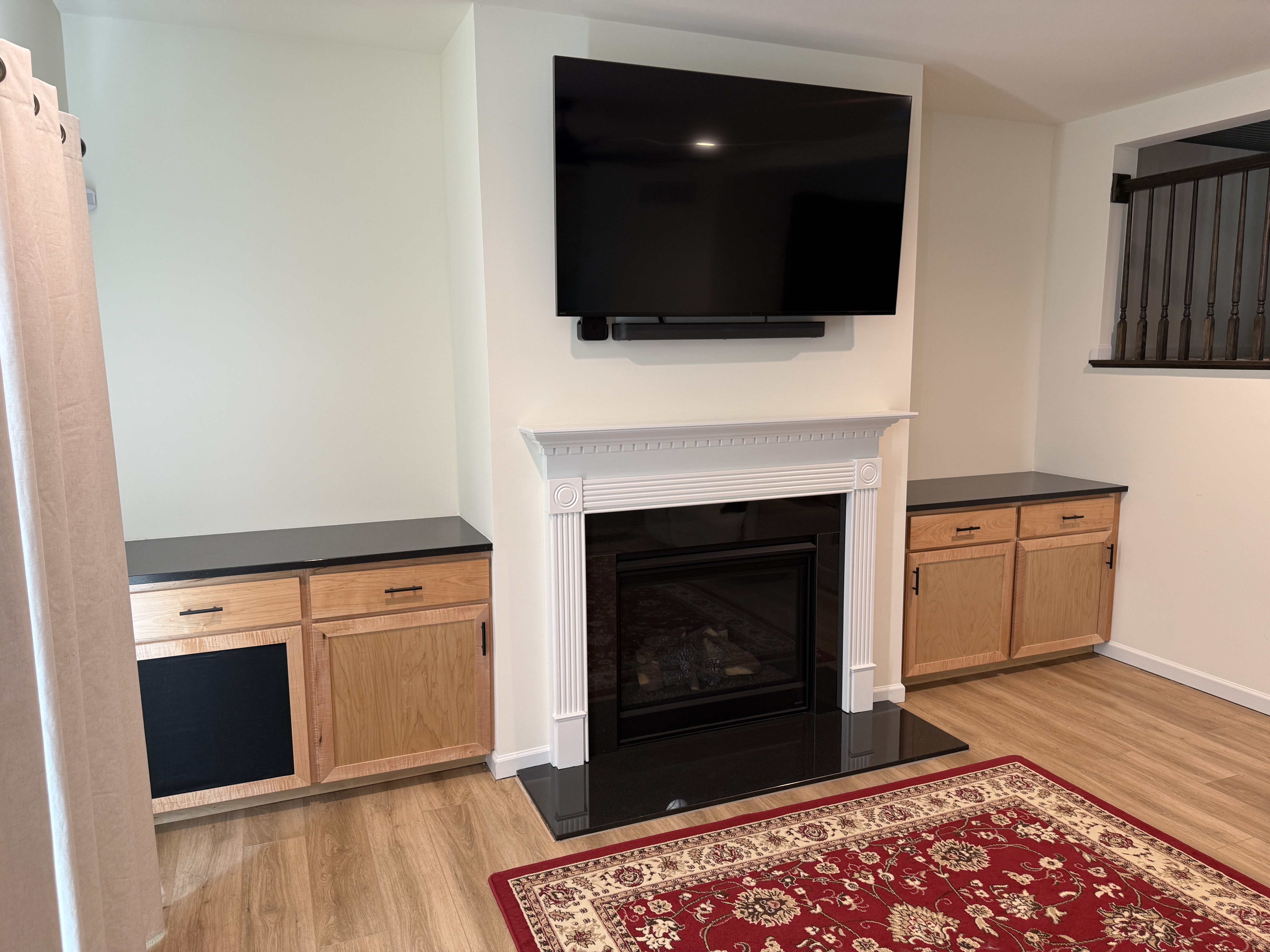 Angled view of custom fireplace built-in cabinetry
